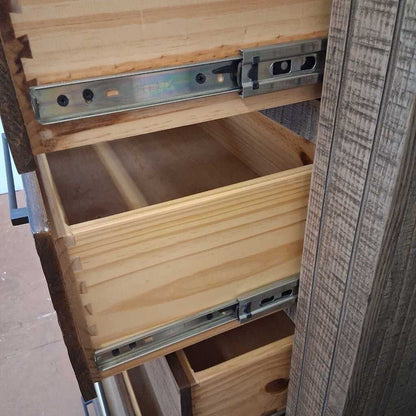 Wooden drawer with metal slides being pulled out