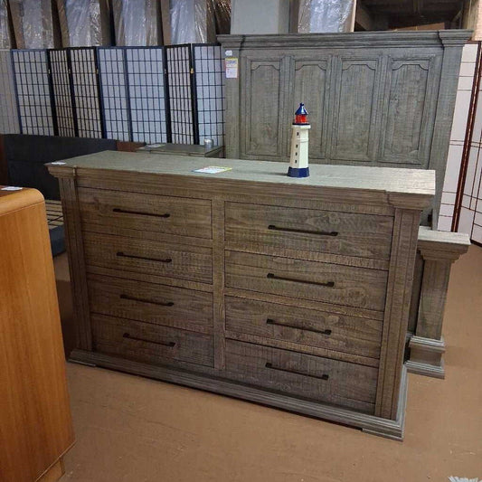 Wooden dresser with multiple drawers in a storage or warehouse setting