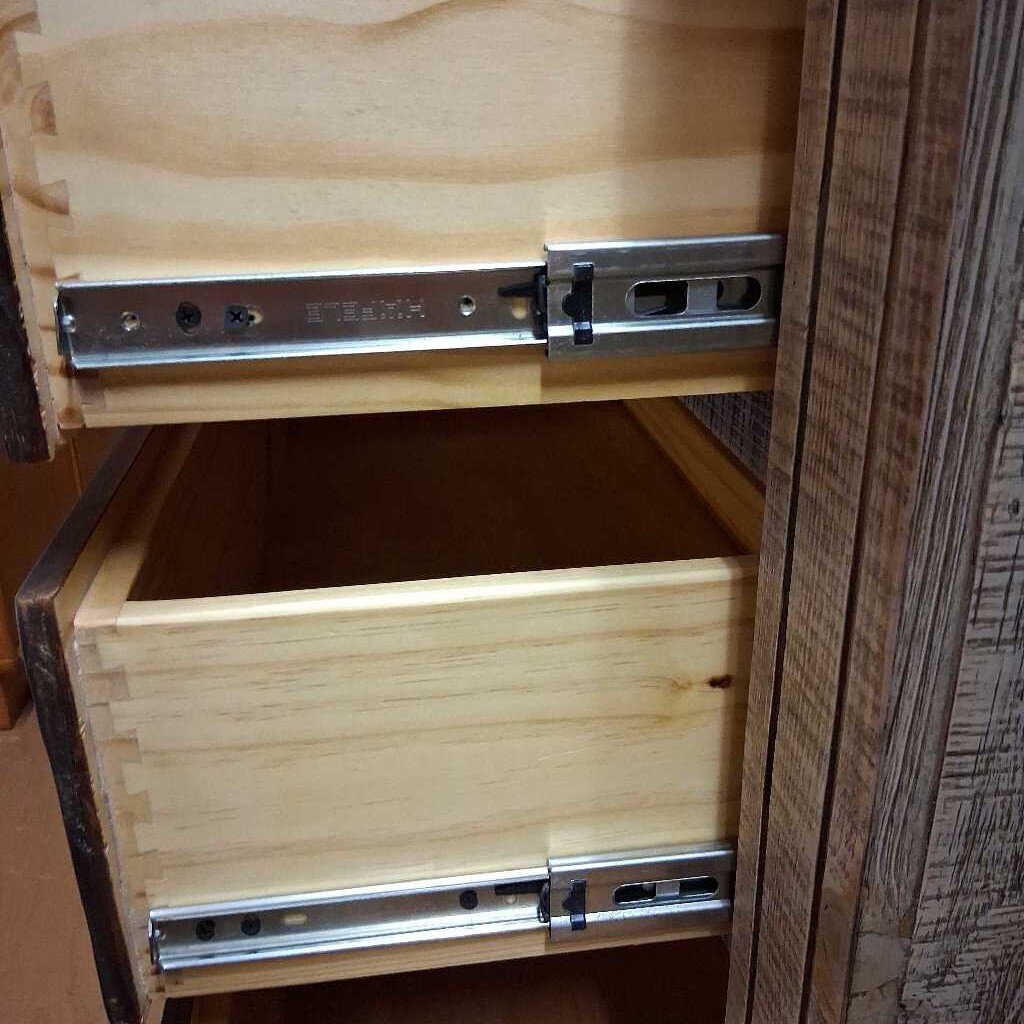 Wooden cabinet with a drawer pulled out, showing metal slides.
