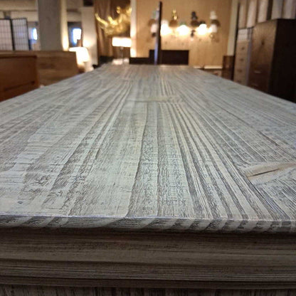 Close-up of a textured mattress surface with a blurred room background