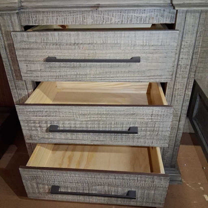 Wooden dresser with three drawers, two of which are open, on a plain background.
