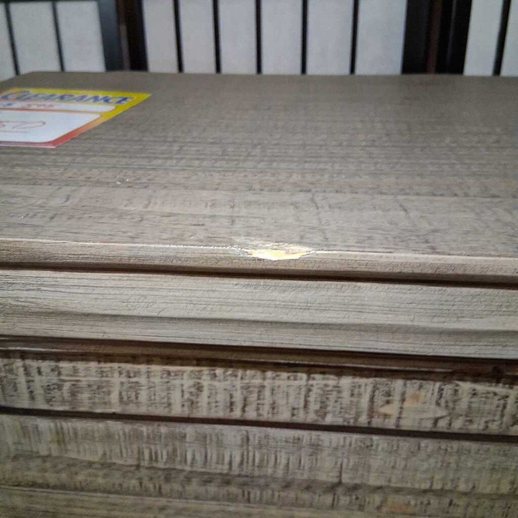 Stack of wooden panels with a visible brand label on a white background