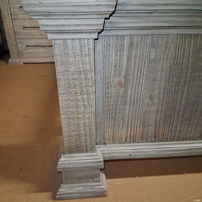 Wooden headboard with a textured finish on a brown surface