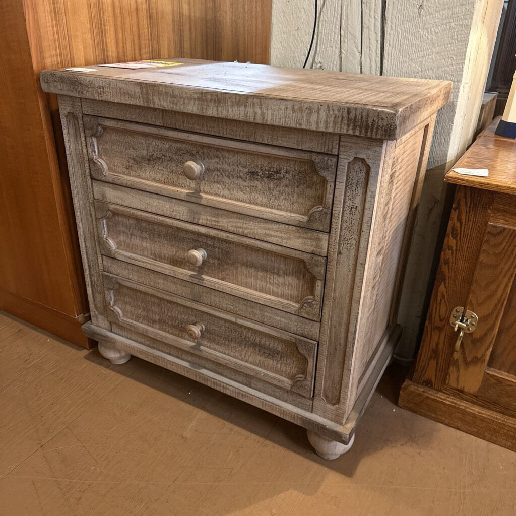 Wooden dresser with four drawers in a room setting