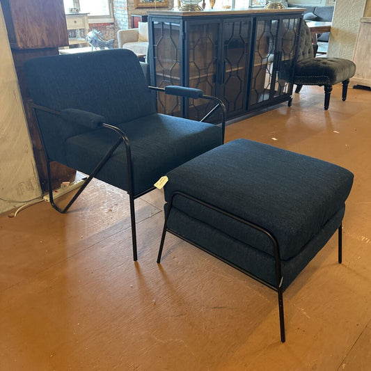 Blue armchair with matching ottoman on a wooden floor