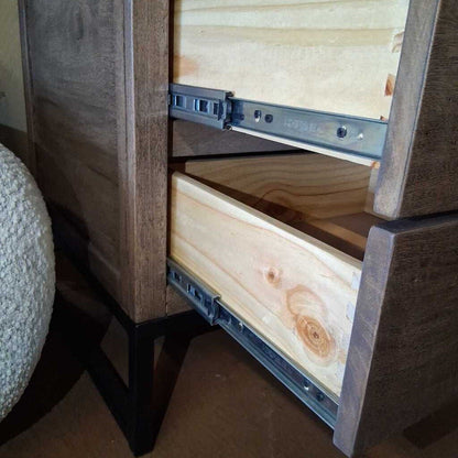 Wooden drawer with metal slides open, showing wooden interior.