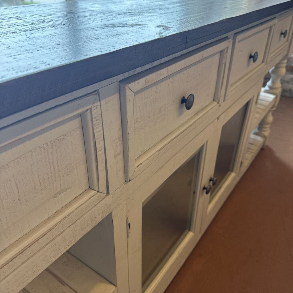 Wooden cabinet with blue countertop on a wooden floor