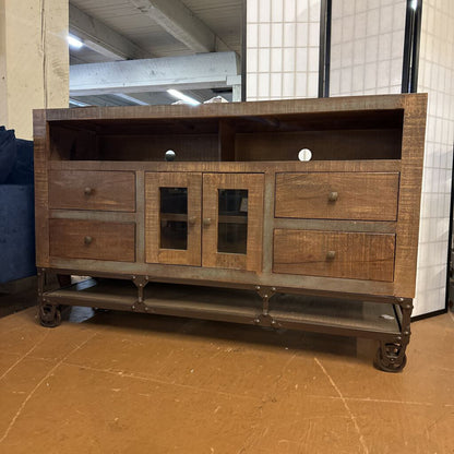 Wooden entertainment console with metal legs in a room setting