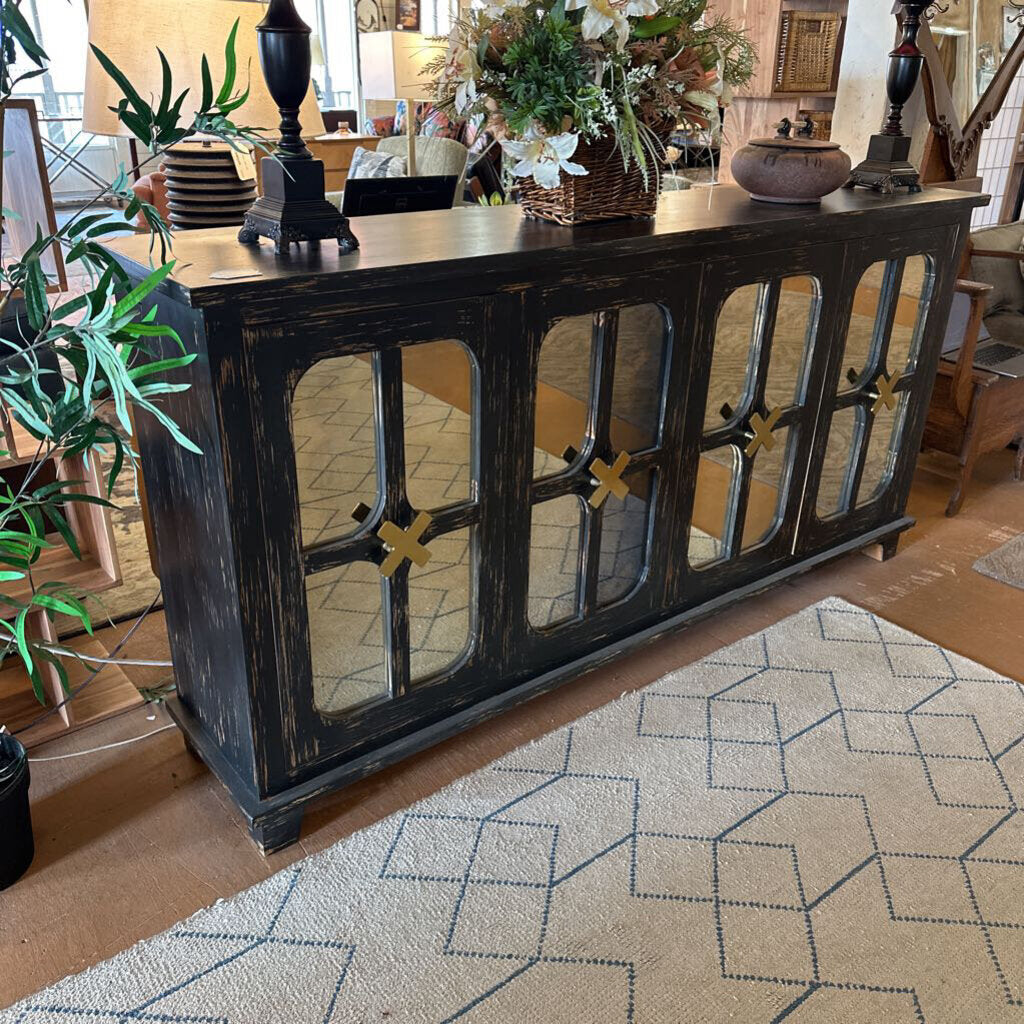 Dark wooden console table with decorative items in a living room setting
