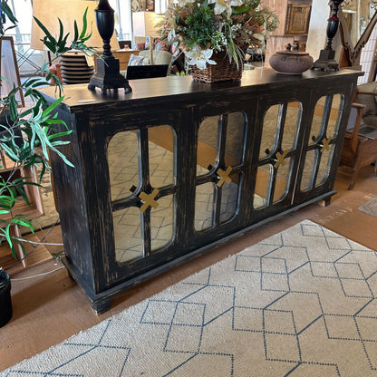 Dark wooden console table with decorative items in a living room setting