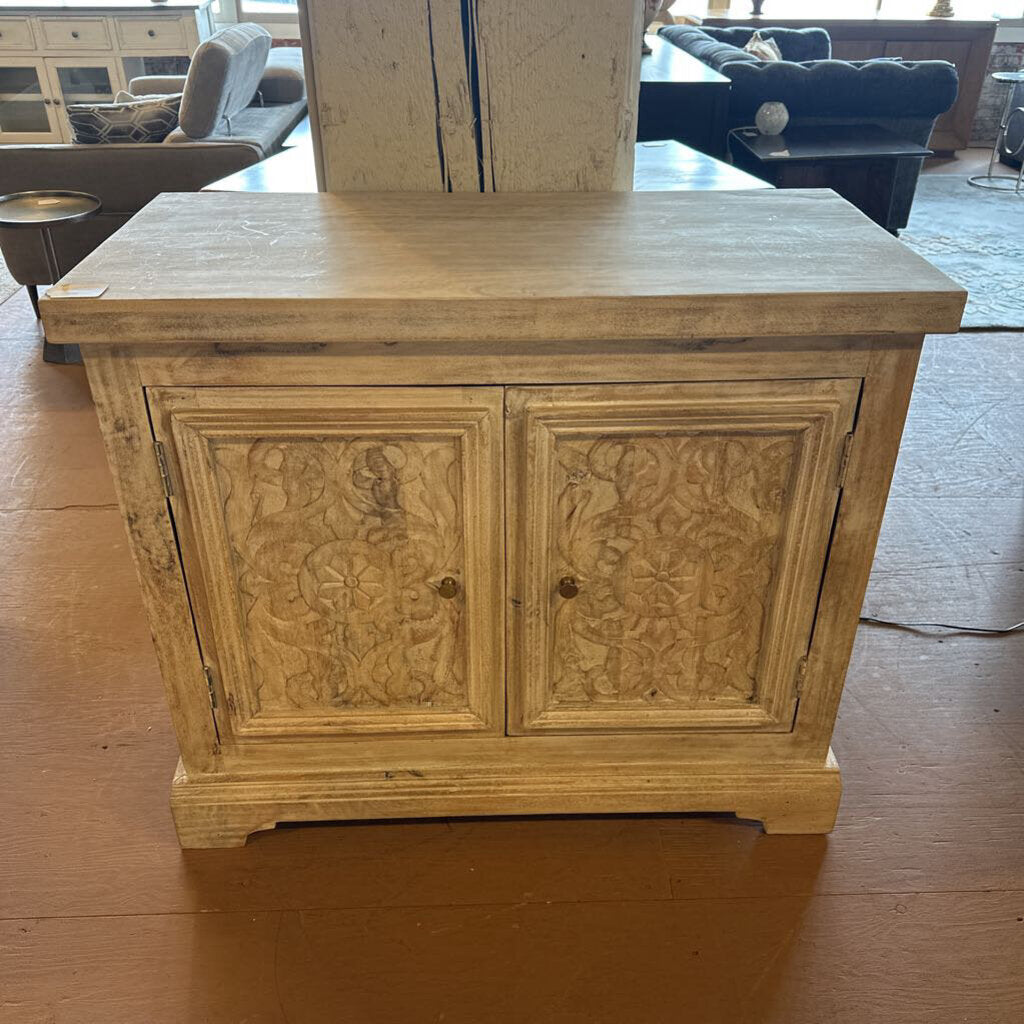 Wooden cabinet with carvings on a wooden floor