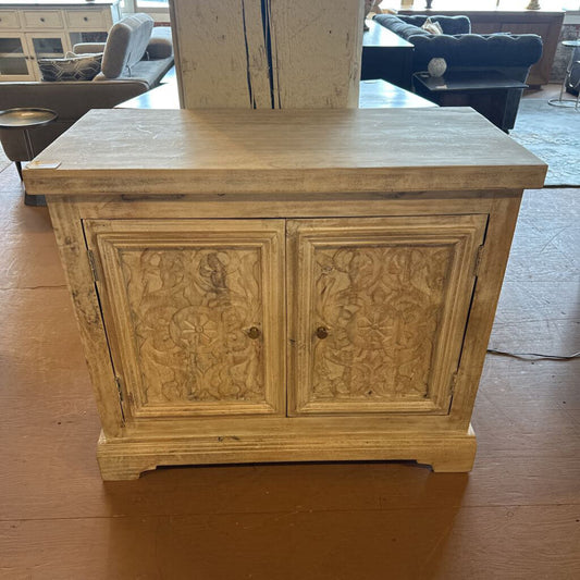 Wooden cabinet with carvings on a wooden floor