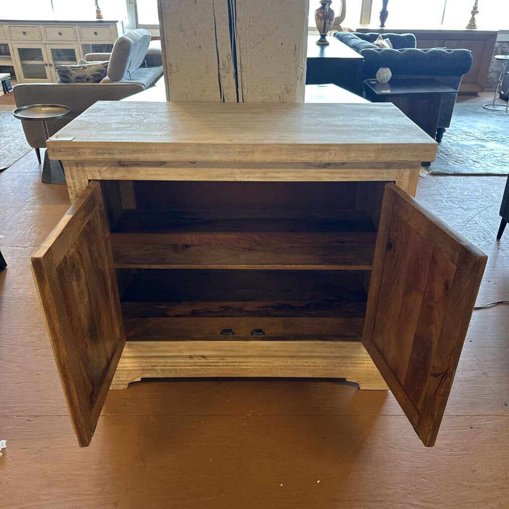 Wooden cabinet with open doors on a wooden floor in a living room setting.