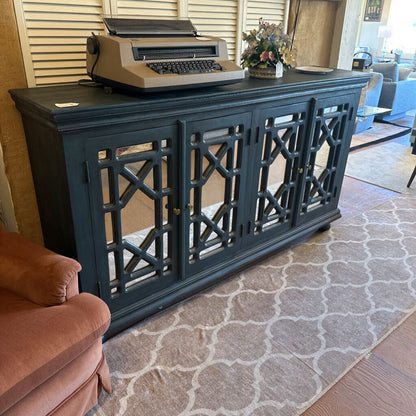 Vintage typewriter on a dark wooden console table in a living room.