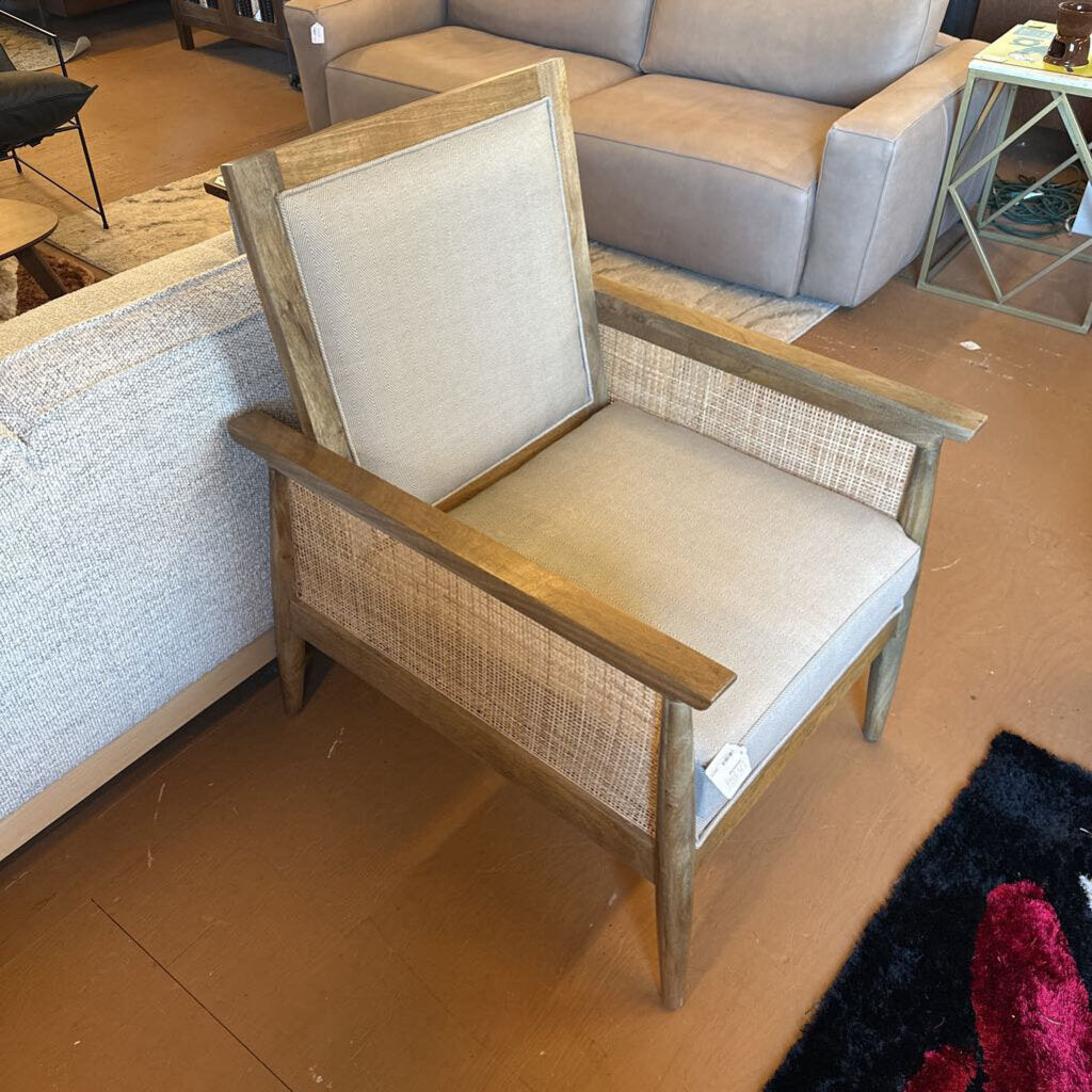 Wooden chair with beige cushion in a store setting