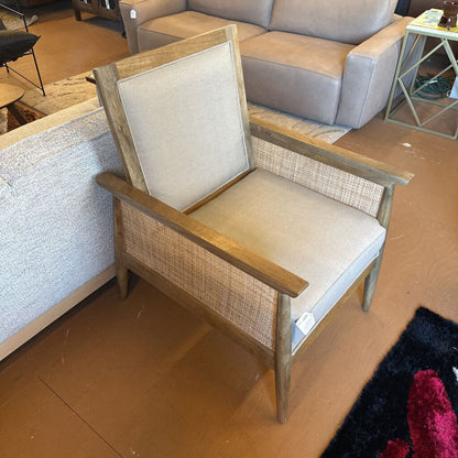 Wooden chair with beige cushion in a store setting