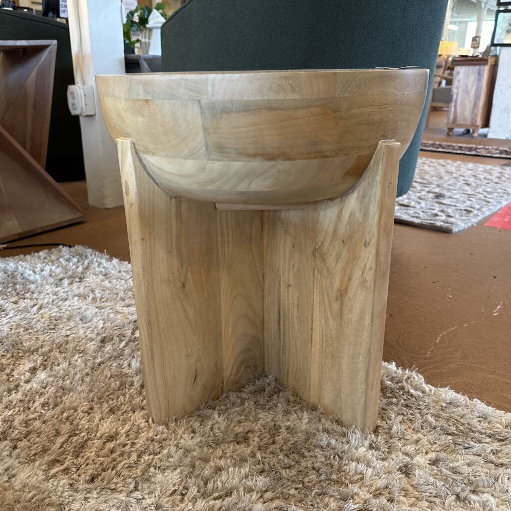 Wooden stool on a carpeted floor with a blurred background