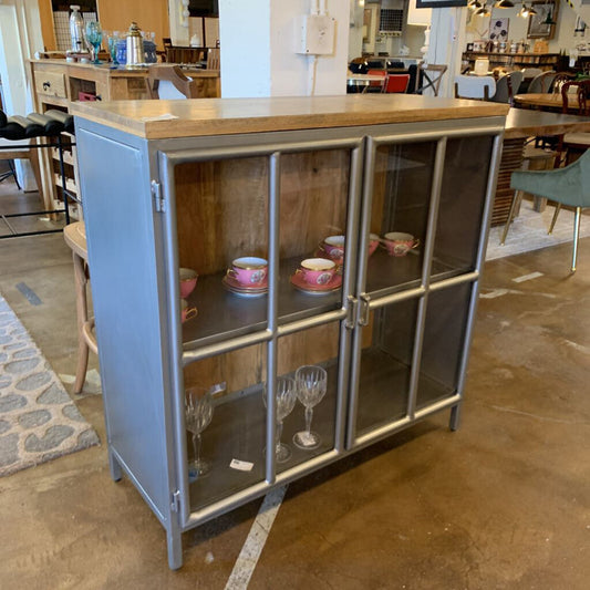 Cabinetry with glass doors displaying decorative items in a store setting