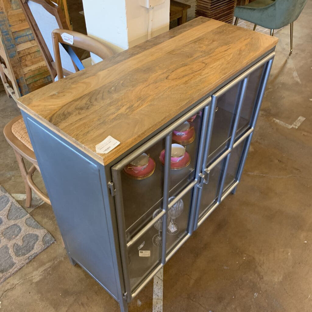 Wooden top cabinet with glass doors in a store setting