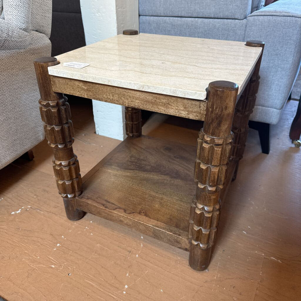 Wooden coffee table with decorative legs in a room setting