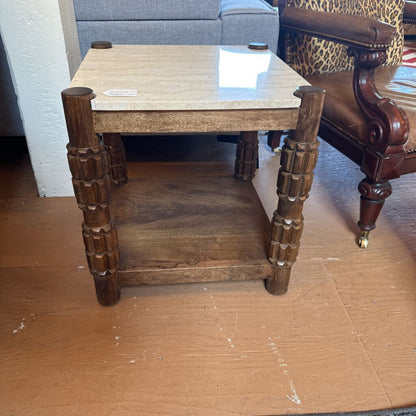 Wooden side table with decorative legs in a room setting