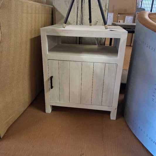 Wooden side table with a cabinet door in a room setting