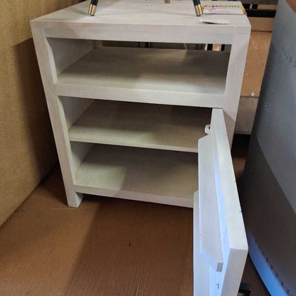 White nightstand with open drawer on a wooden floor