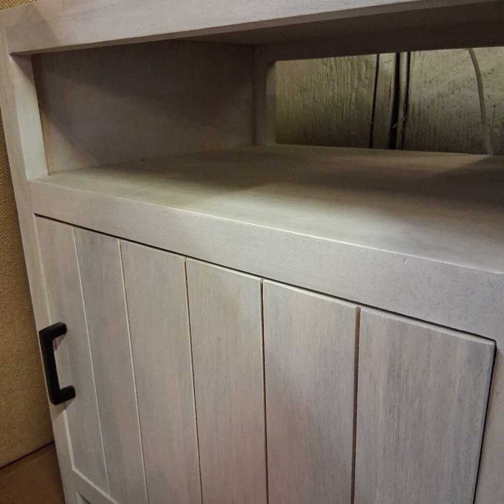 Wooden cabinet with a countertop and a handle on a neutral background