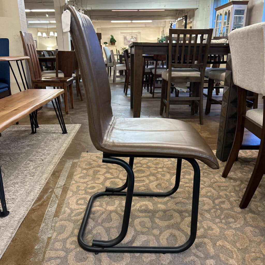 Brown chair with black metal frame in a furniture store setting