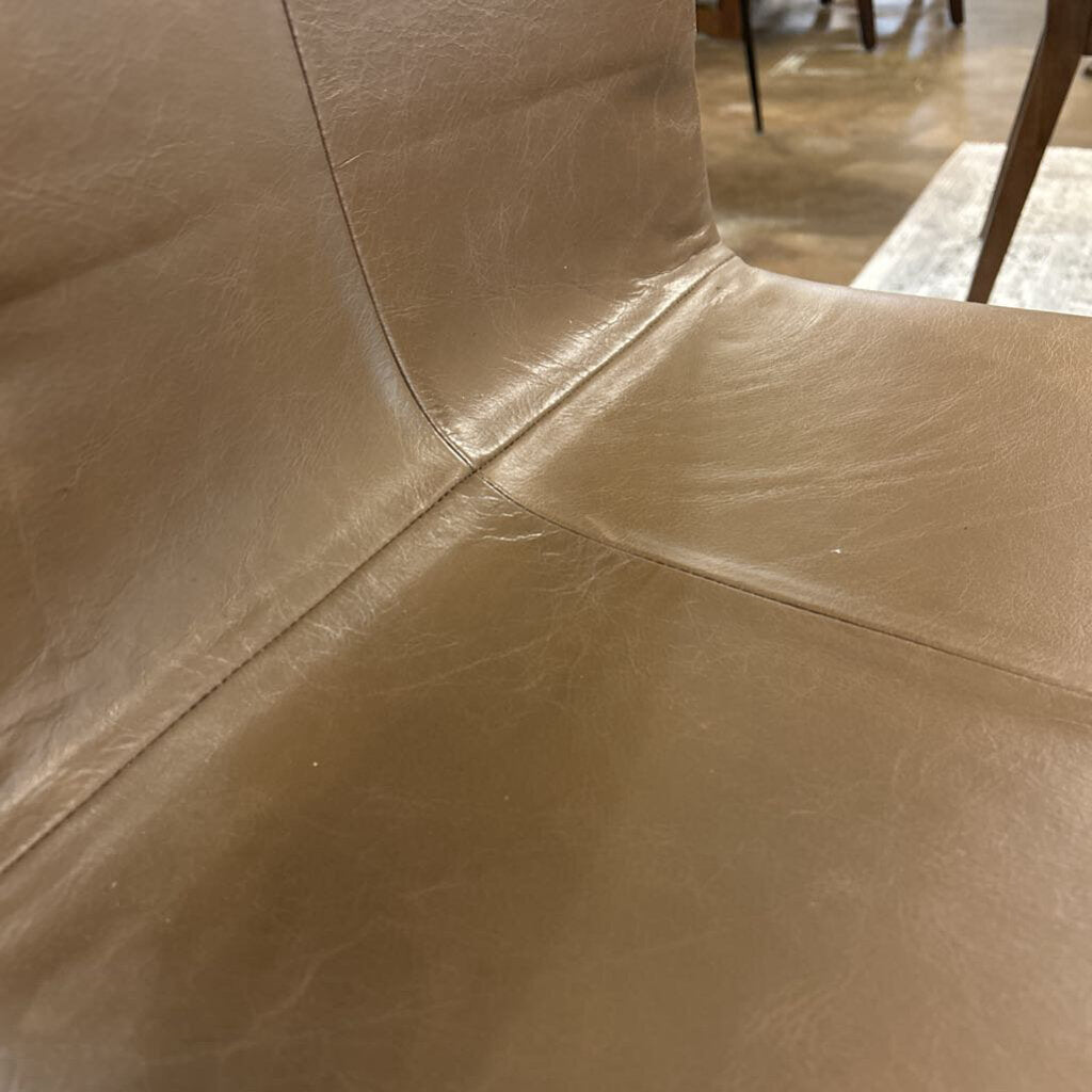 Close-up of brown leather surface with visible stitching