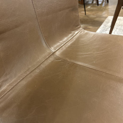 Close-up of brown leather surface with visible stitching