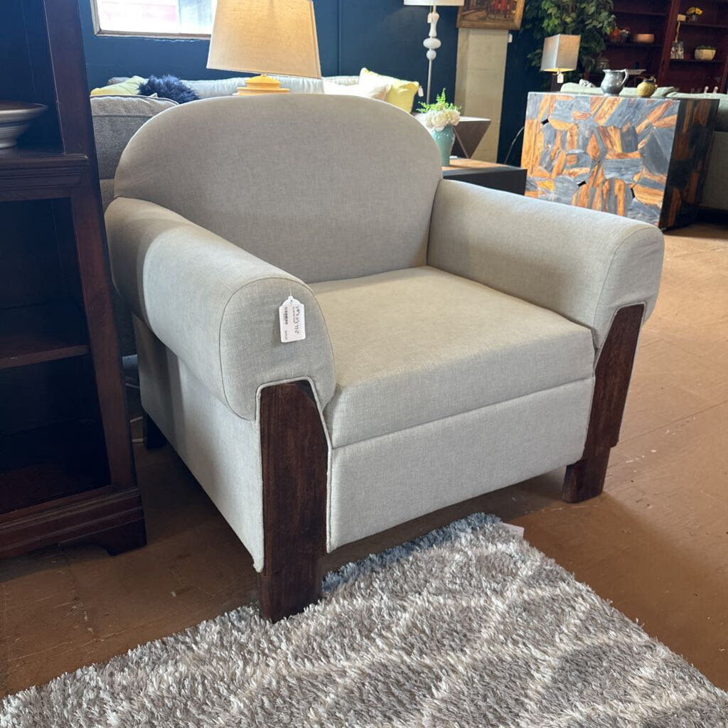 Gray armchair with wooden arms in a room setting