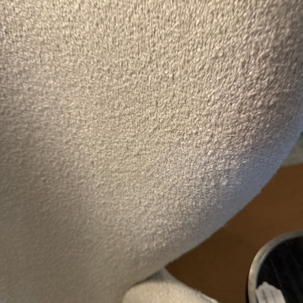 Close-up of textured ceiling and corner of a room.