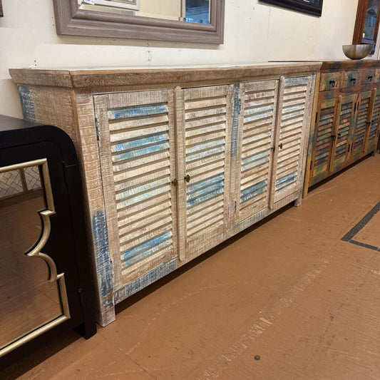 Wooden cabinet with shutter-style doors on a wooden floor.
