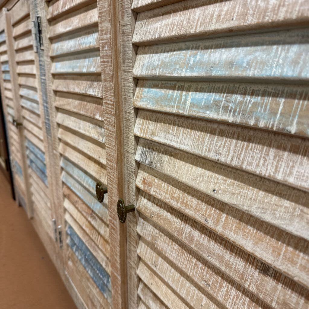 Close-up of wooden louvered doors with a focus on texture and color.