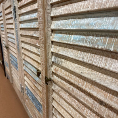 Close-up of wooden louvered doors with a focus on texture and color.
