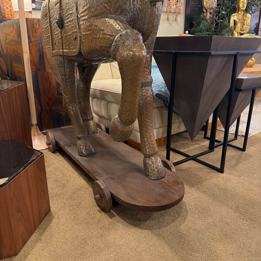 This monumental Indian-style Ashva horse statue is a masterwork of decorative craftsmanship, designed to serve as a grand focal point in a high-end interior. The statue is finished in a highly detailed antiqued brass or bronze-toned metal, featuring intricate embossed patterns that mimic traditional ceremonial armor and tack.