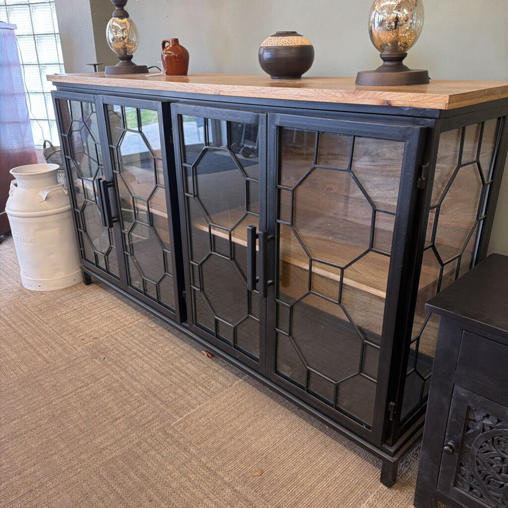 Black metal cabinet with glass panels on a carpeted floor