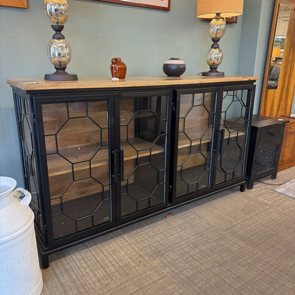 Black metal cabinet with glass doors in a room setting