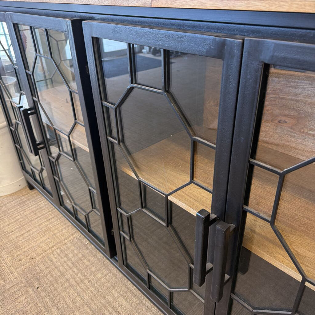 Decorative metal screen with geometric design on a wooden surface