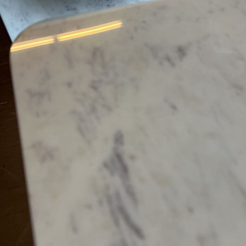 Close-up of a marble surface with visible veins and imperfections