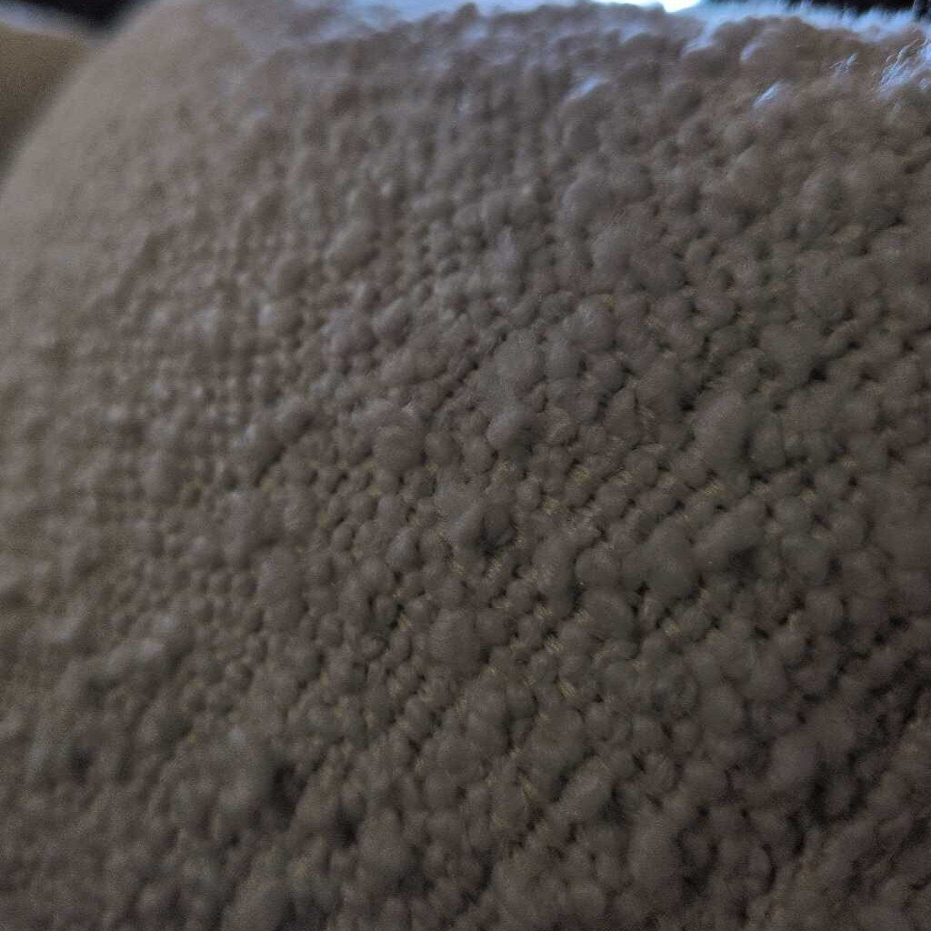 Close-up of a textured beige fabric surface