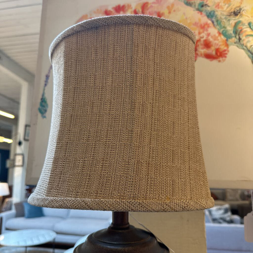 Textured beige lampshade on a blurred indoor background