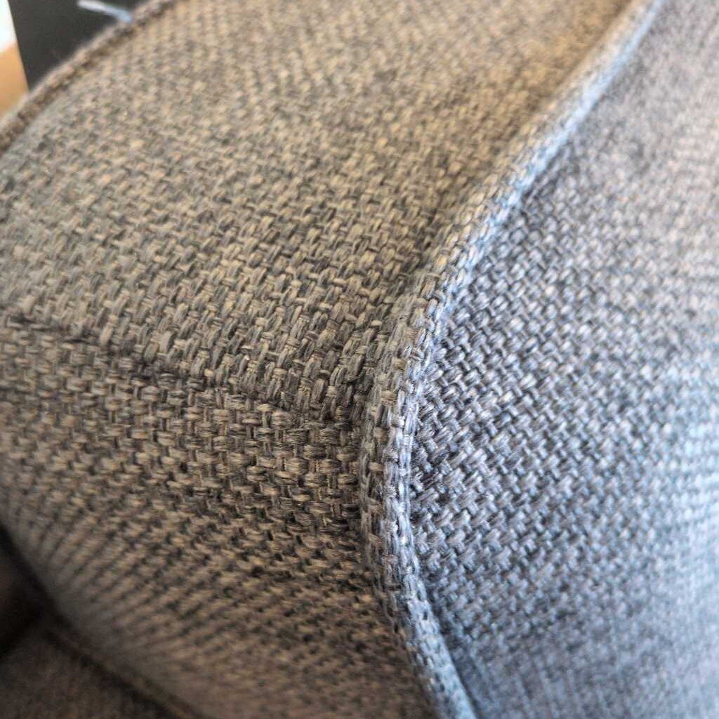 Close-up of textured fabric surface with a blend of brown and gray colors.