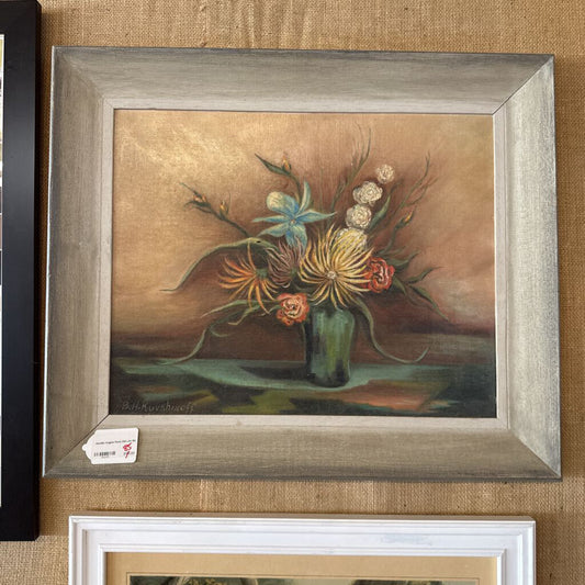 Framed still life painting of flowers on a textured wall