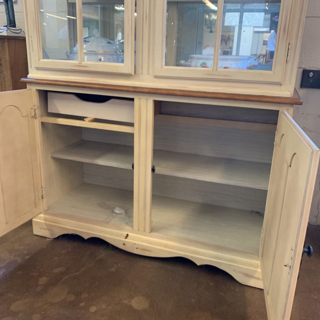 Empty wooden cabinet with glass doors in a room setting