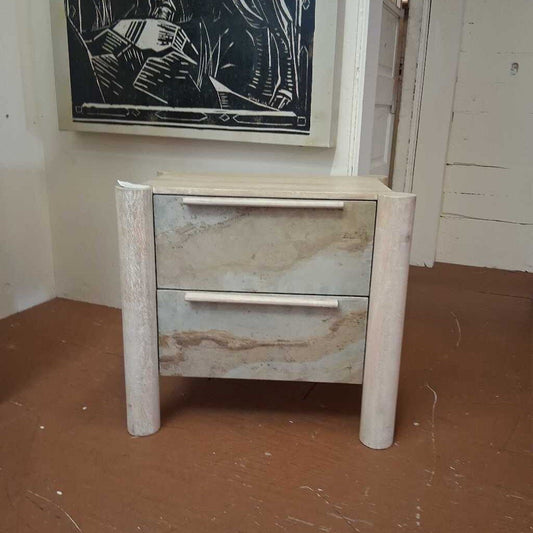 Two-drawer nightstand with marble-like finish in a room setting.