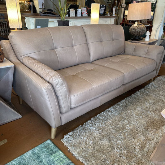 Gray sofa in a room with a rug and furniture