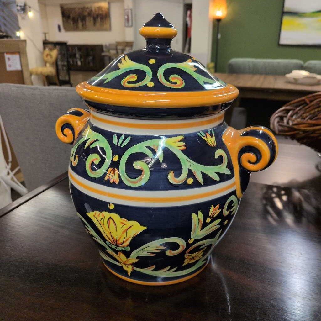 Decorative ceramic jar with floral patterns on a wooden table