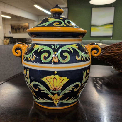 Decorative ceramic jar with floral patterns on a wooden surface